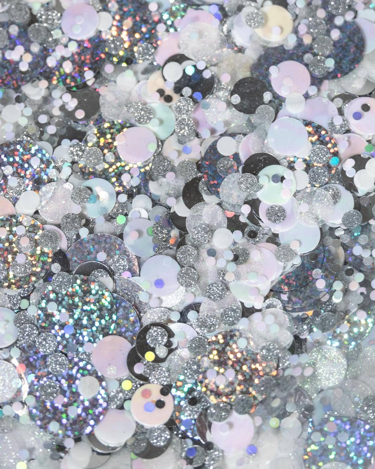 A clear, silver confetti tote bag with iridescent straps.