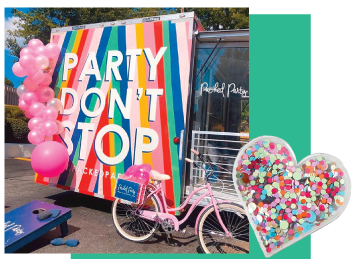 A party trailer surrounded by pink balloons.