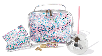 A multicolored confetti lunchbox alongside a confetti stapler, tape dispensar, and disco ball sipper.