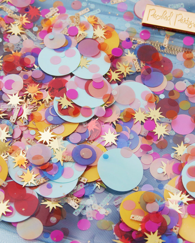 Closeup view of Celebrate confetti mix, colorful mix with circle, sprinkle, and starburst shape. Pink, blue, yellow, red and gold confetti and more!