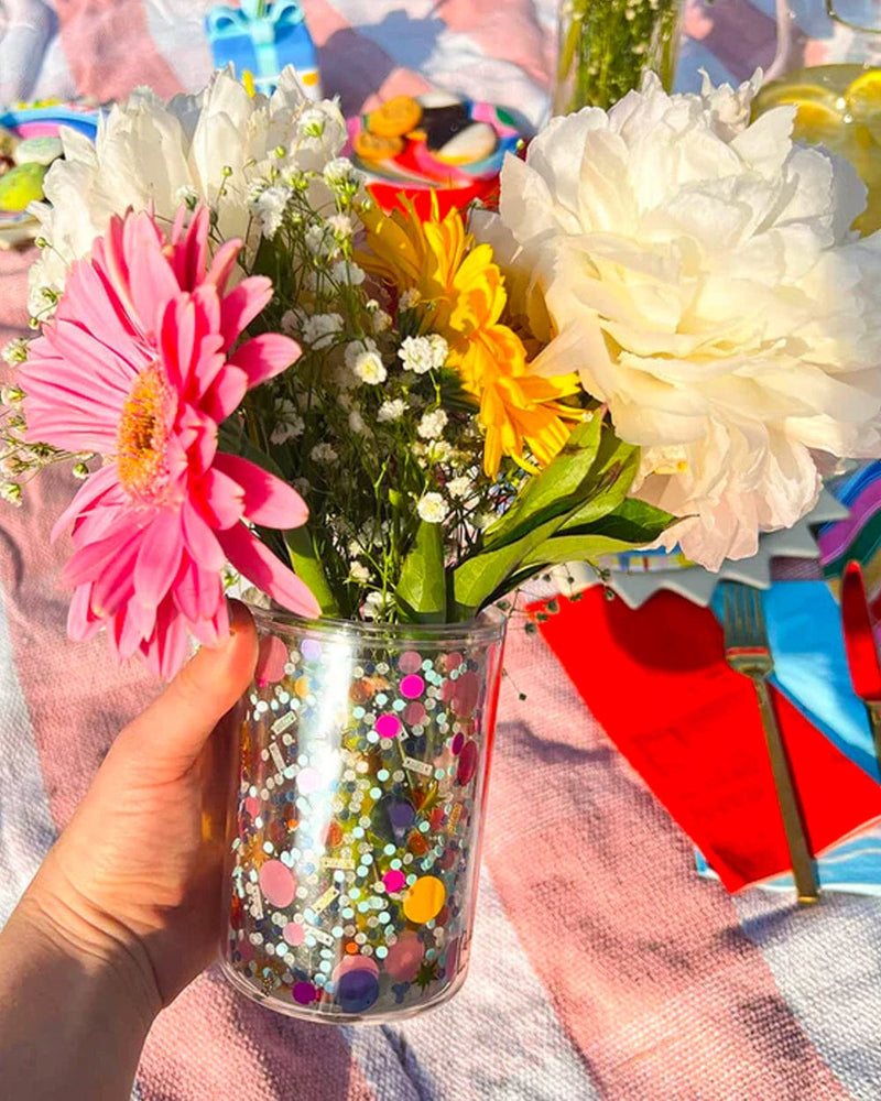 Flower vase for cute mini bouquet. Cup filled with pink flower, yellow, white and baby's breath
