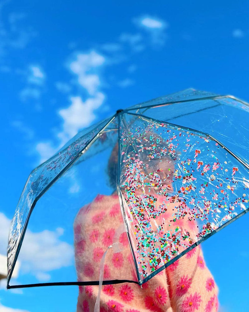Cute Confetti umbrella with girl holding it.