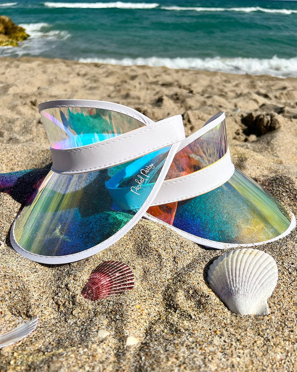 two holographic visors in sand beach with ocean in background fun party