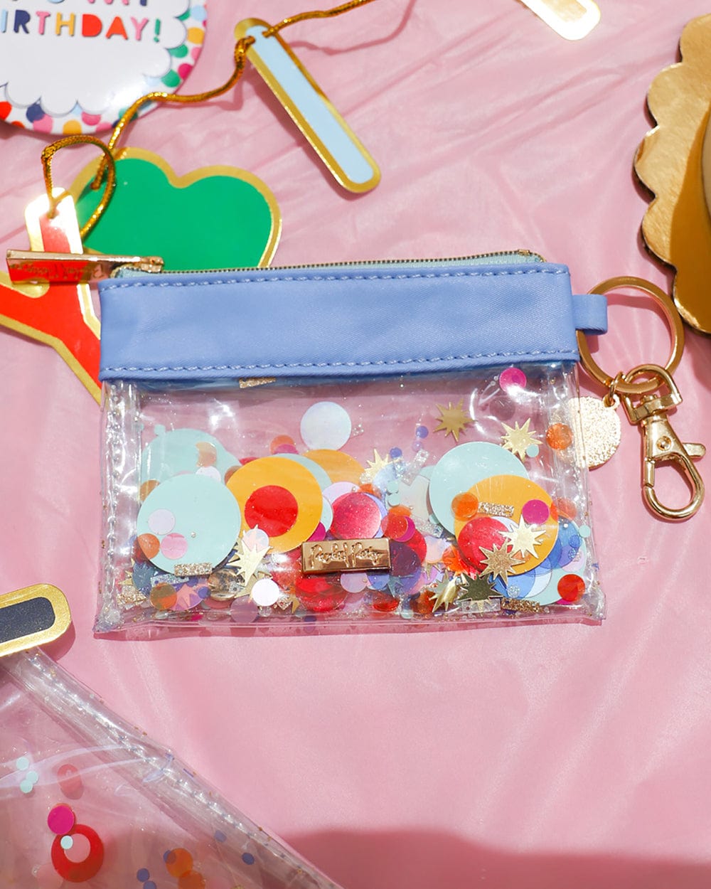Light blue nylon lining, clear confetti filled vinyl and gold clip and ring.
