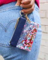 girl holding our signature colorful confetti wallet, keychain cute on-the-go look paired with denim jeans
