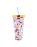 A confetti tumbler with a gold lid and light blue straw.