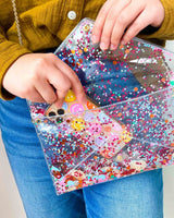 Cute clear purse with confetti and a phone