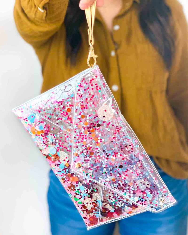 Girl holding up a clear clutch by its handle