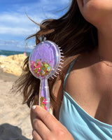 girl hairbrush pastel purple confetti hair styling beach sun