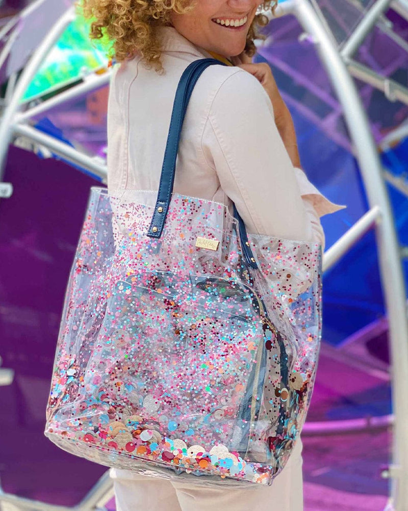 Girl holding the Packed Party Essentials Bucket bag smiling and on the go in the city