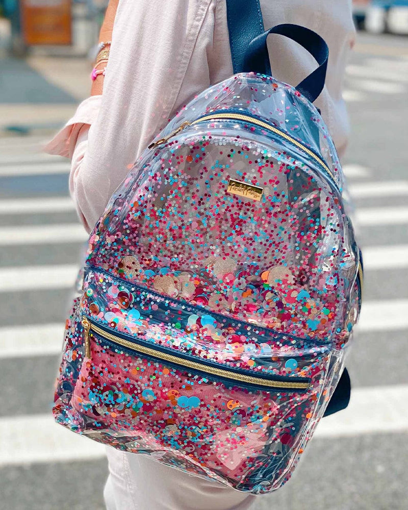 Cute blue backpack with trapped colorful confetti on a lady walking across a street
