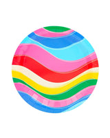 A colorful, circular plate that has multicolored waves on it in front of a white background