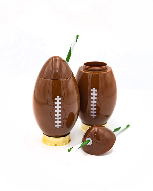 Football shaped novelty sipper with a golden base and striped green and white straw.