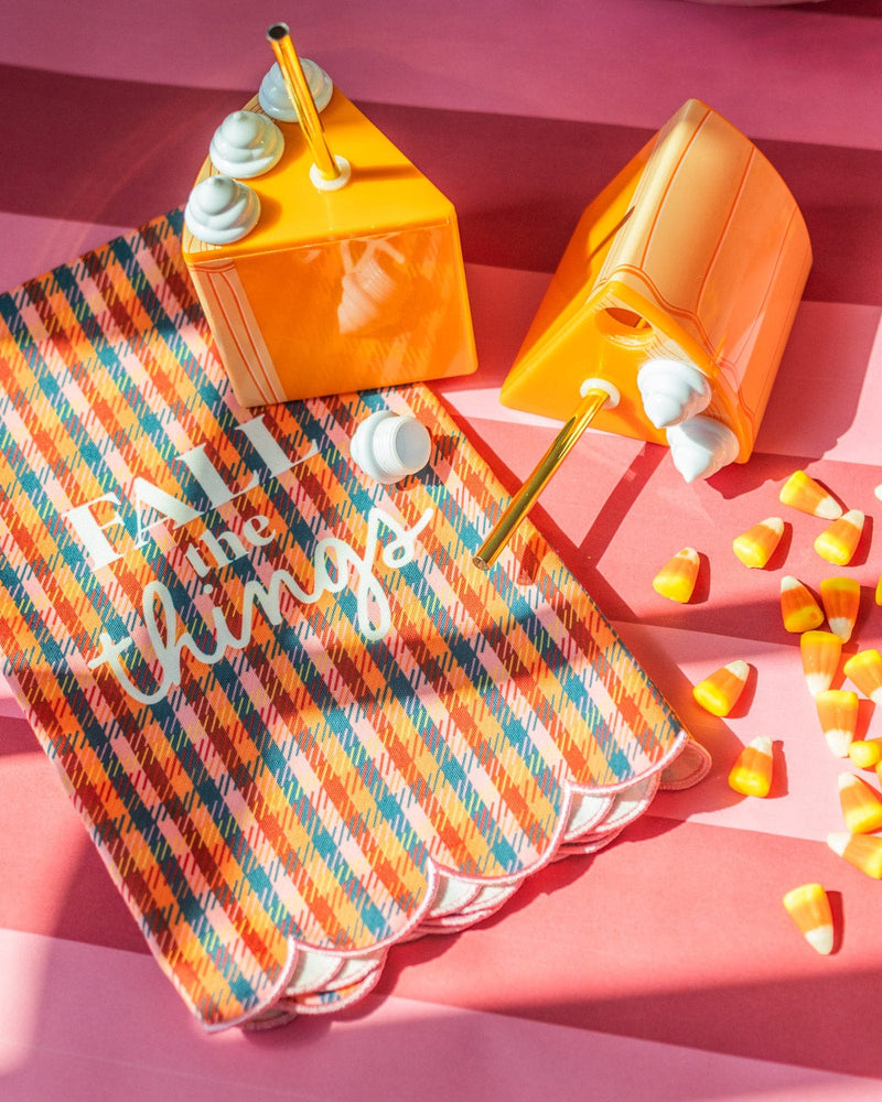 Two pumpkin pie sippers with gold straw, candy corn, and girly houndstooth towel. 