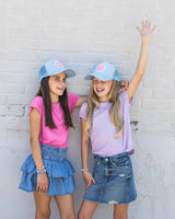 two girls smiling with cute foam hat with mesh back