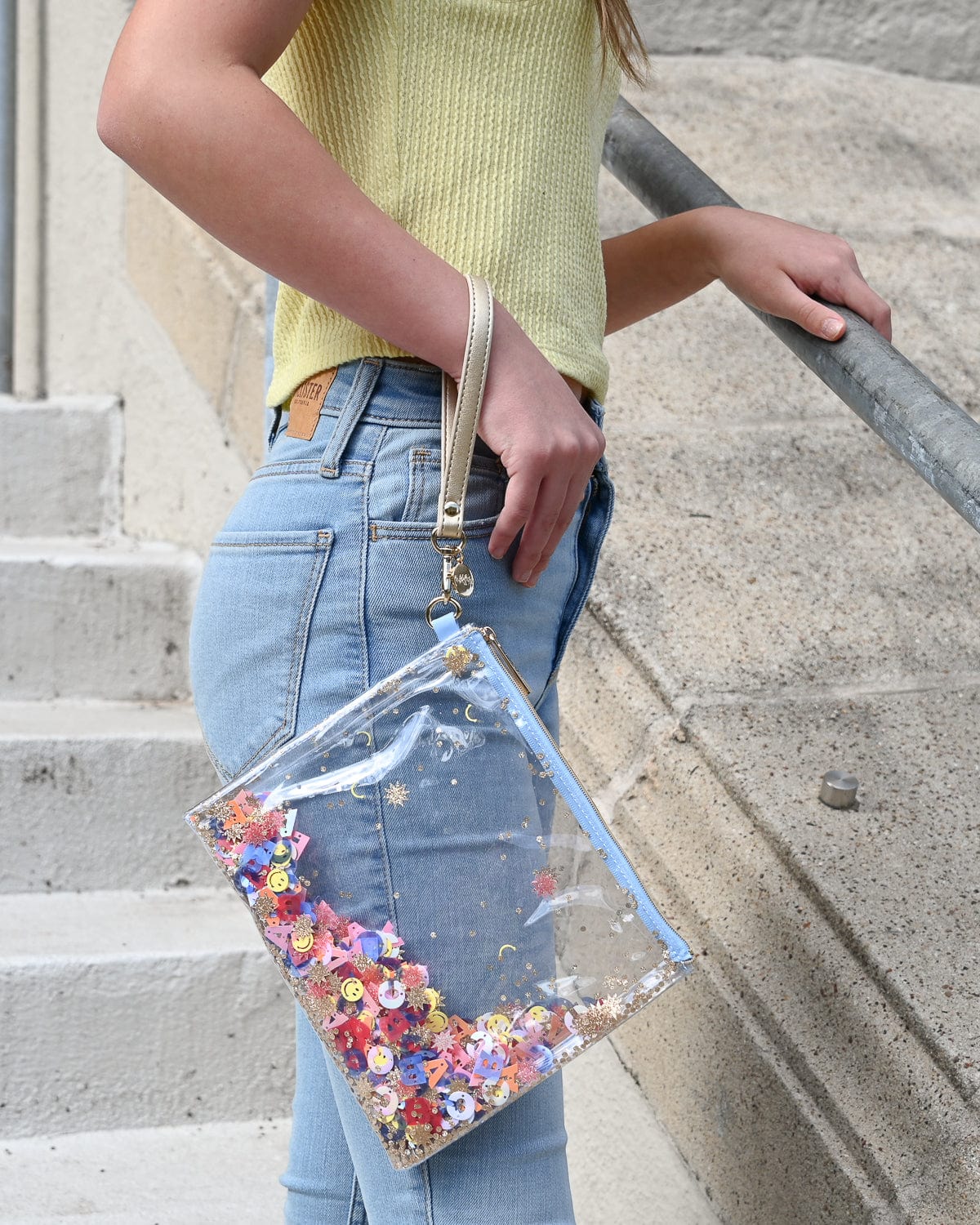 Hand strap for wallet or clutch attached to everything pouch.