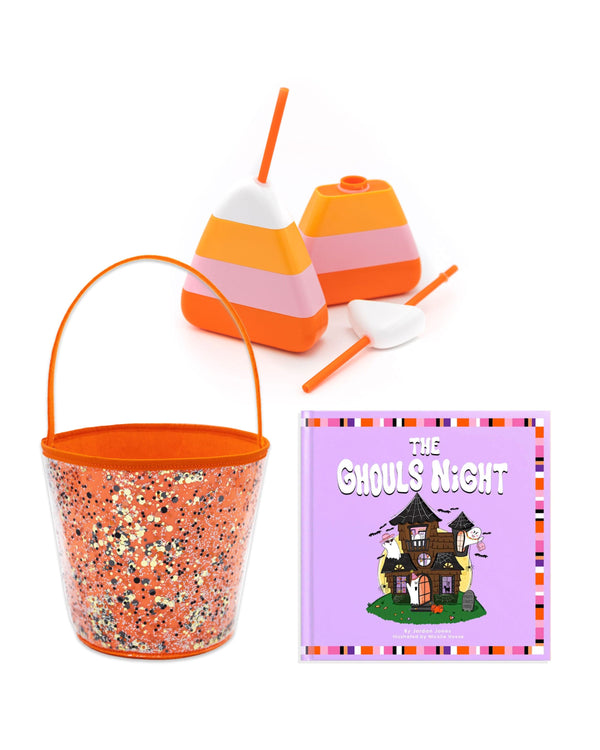 A candy corn sipper alongside an orange confetti bucket and a book titled "The Ghouls Night".
