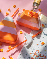 Candy corn sipper with wine pouring into it. 