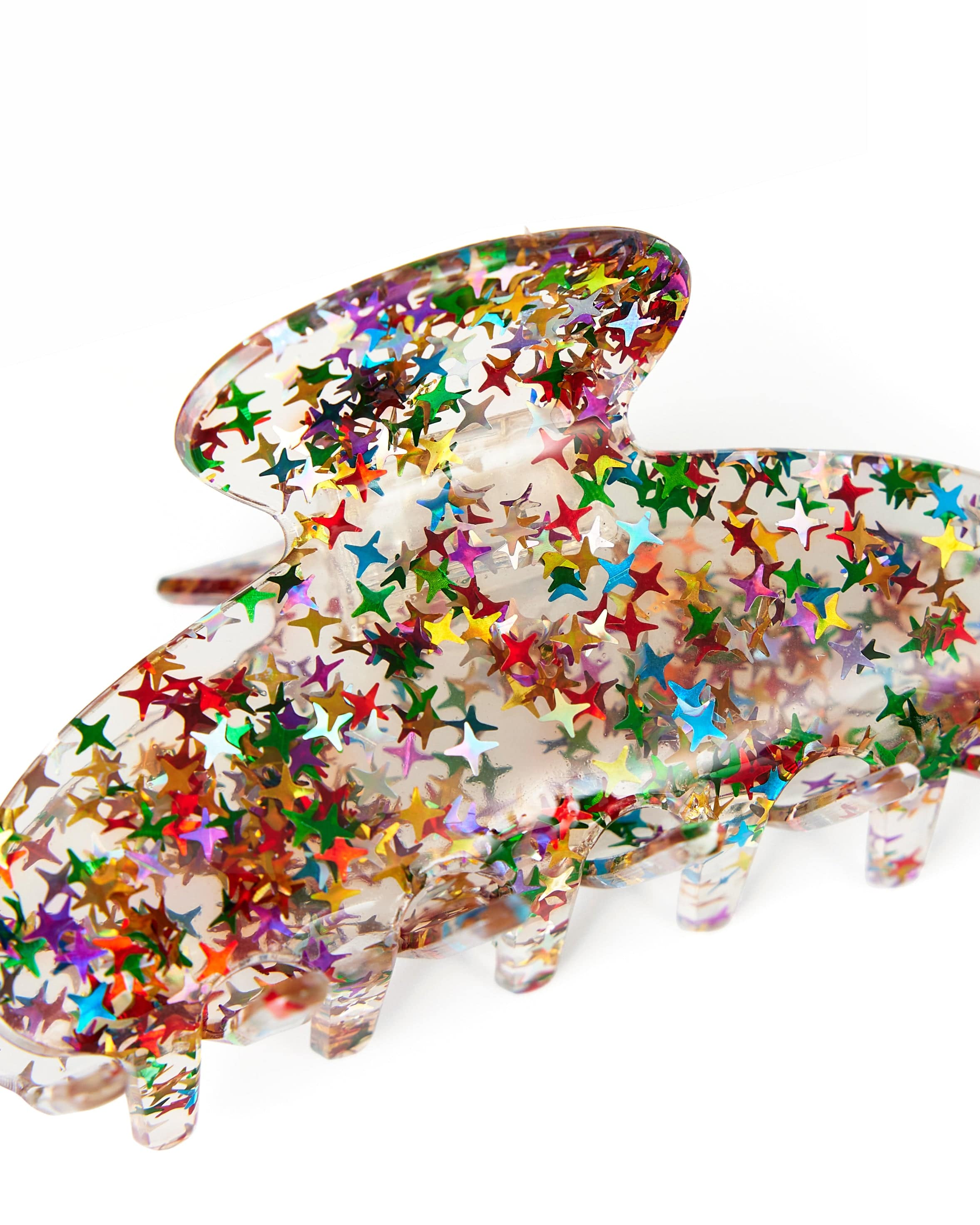 Close up of a clear claw clip with rainbow stars.