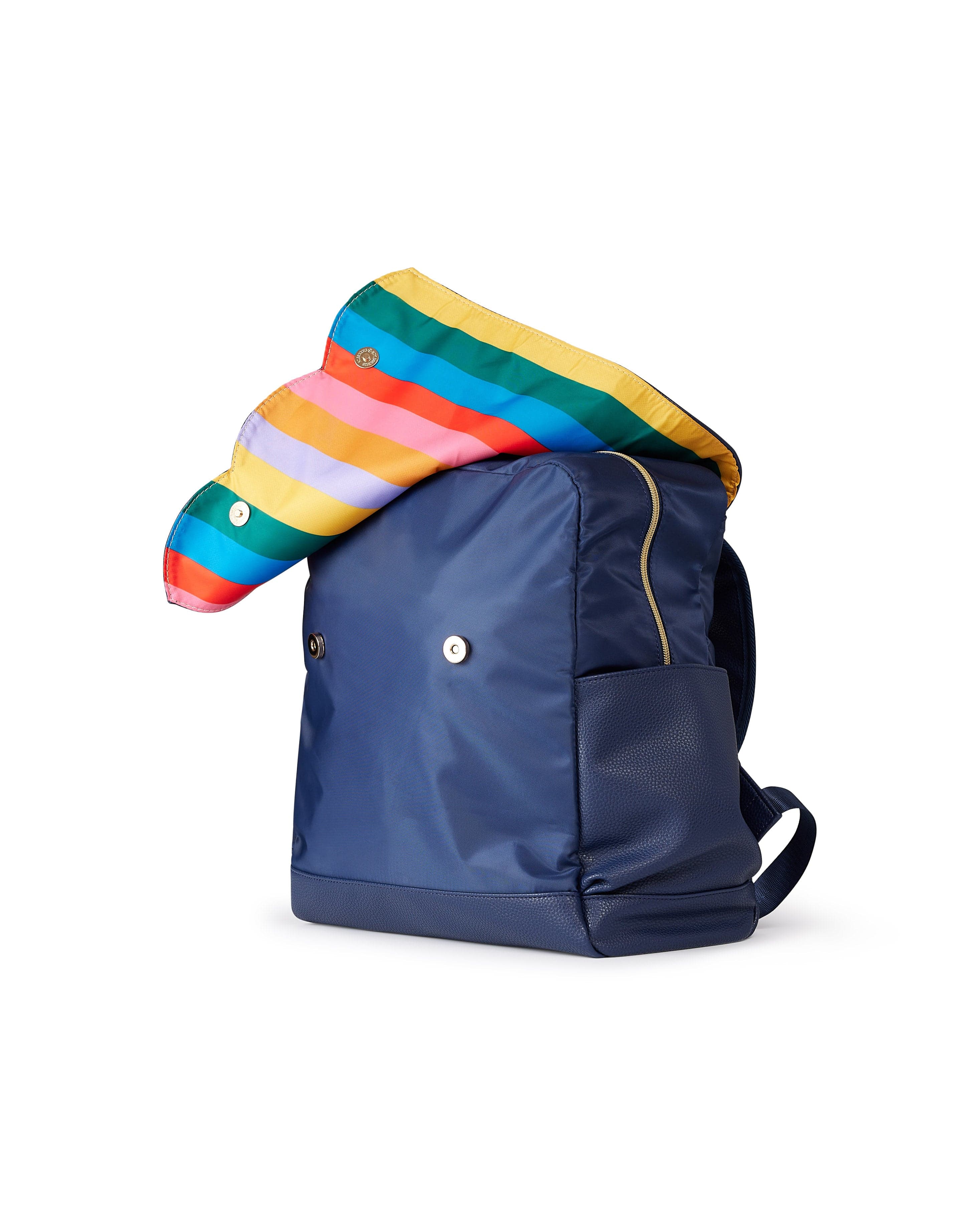 navy diaper bag backpack with flap open to reveal rainbow striped interior lining
