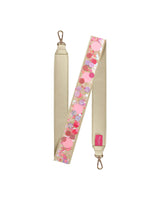 Pink confetti strap folded in half showing off gold leatherette material and gold hardware.