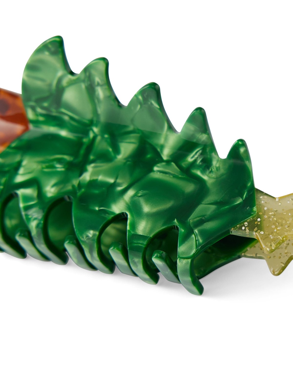 Close up of textures in Christmas tree claw clip shot against white background. 