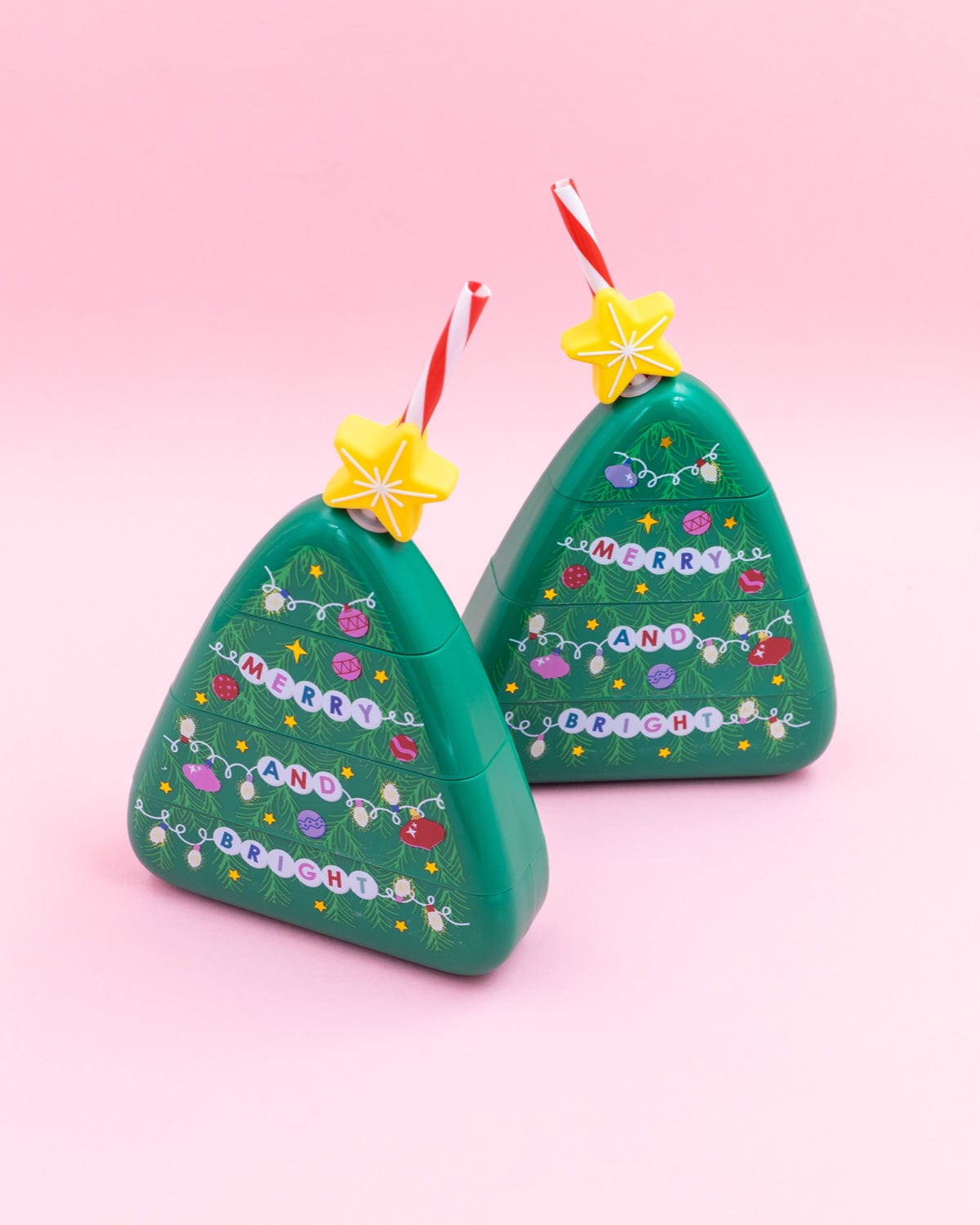 Two Christmas Tree Sippers shot against pink background. 