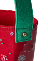 Close up of green felt strap and gold hardware of confetti wine bag shot against white background. 