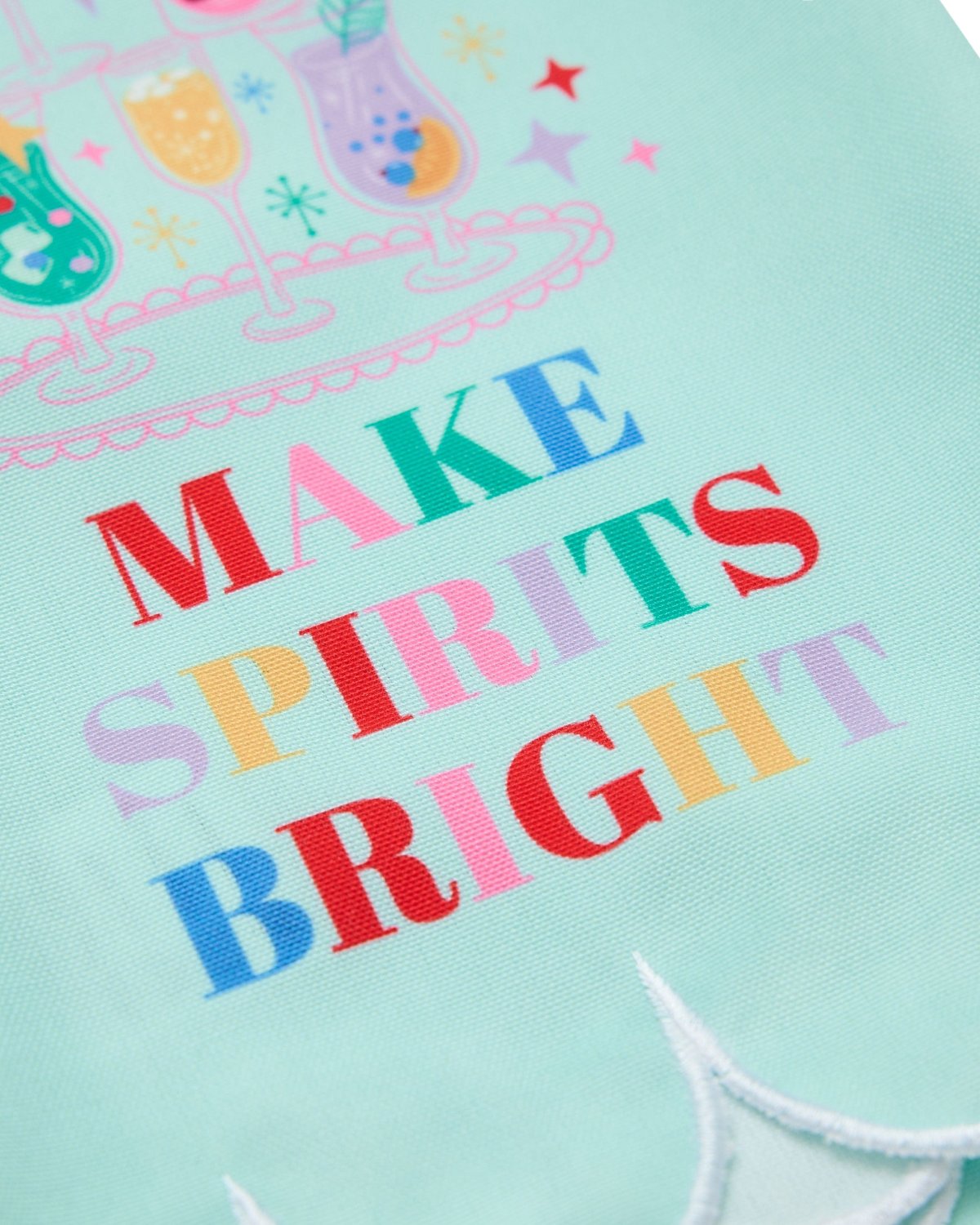 Close up of 'Make Spirits Bright' printed text, cocktail design, and scalloped edge detail. 