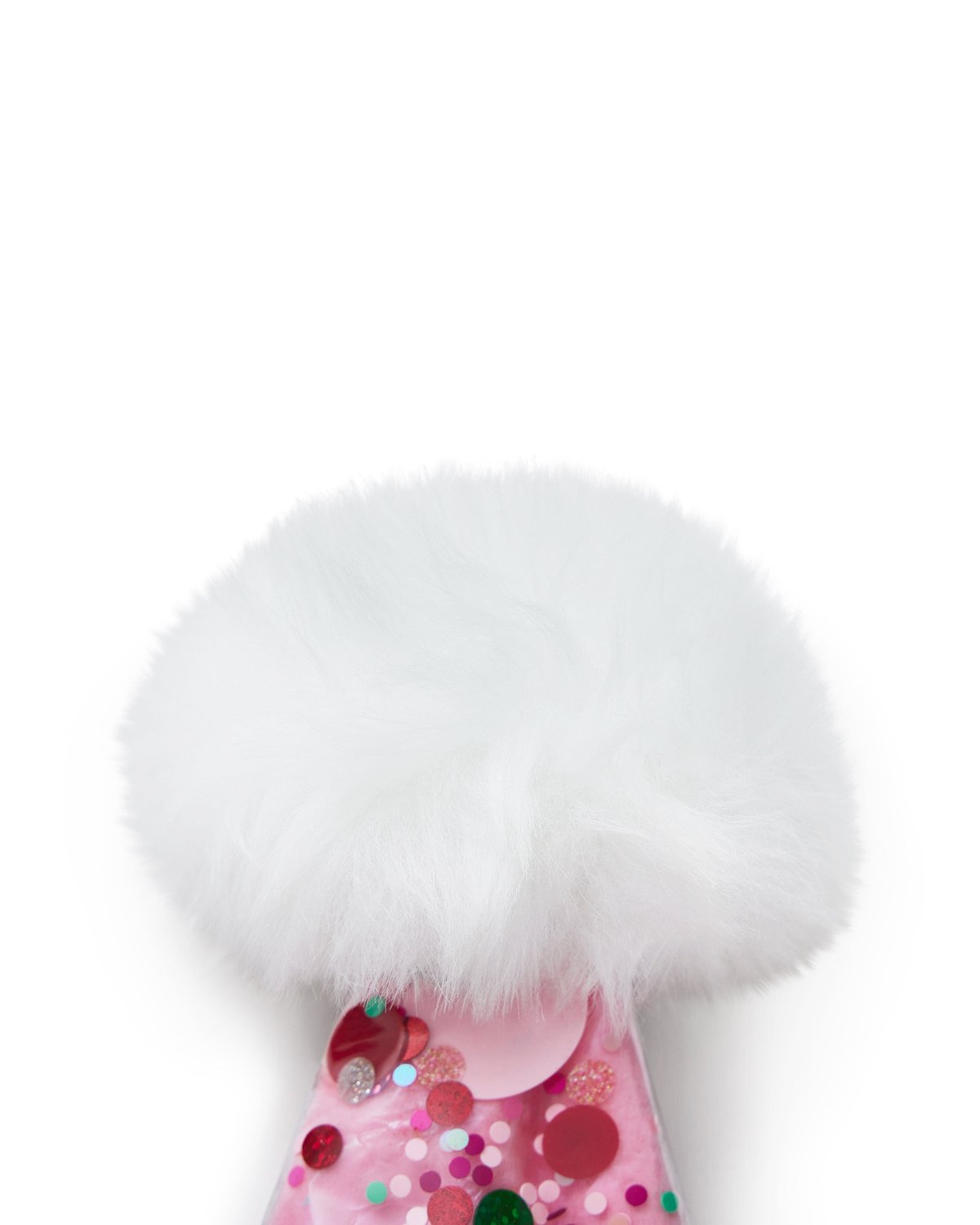 Close up of faux fur detail at top of pink confetti santa hat shot against white background. 