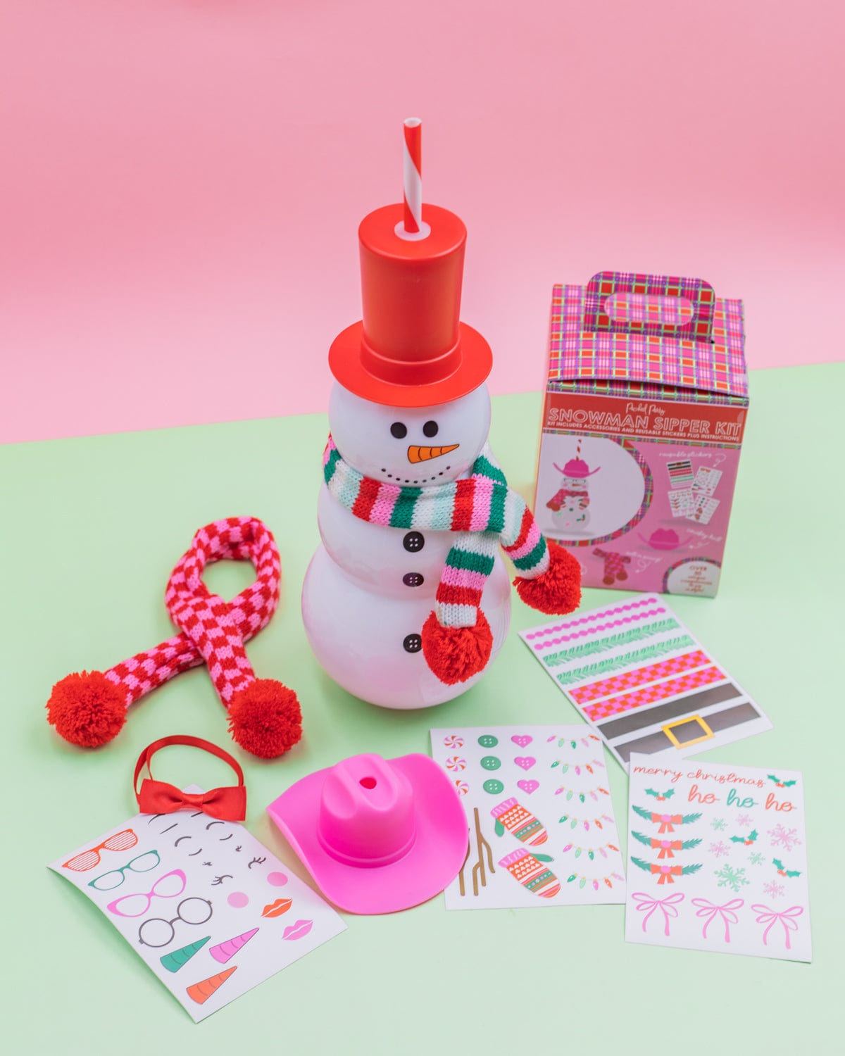 Snowman Sipper Accessory Bundle shot against green and pink background. 