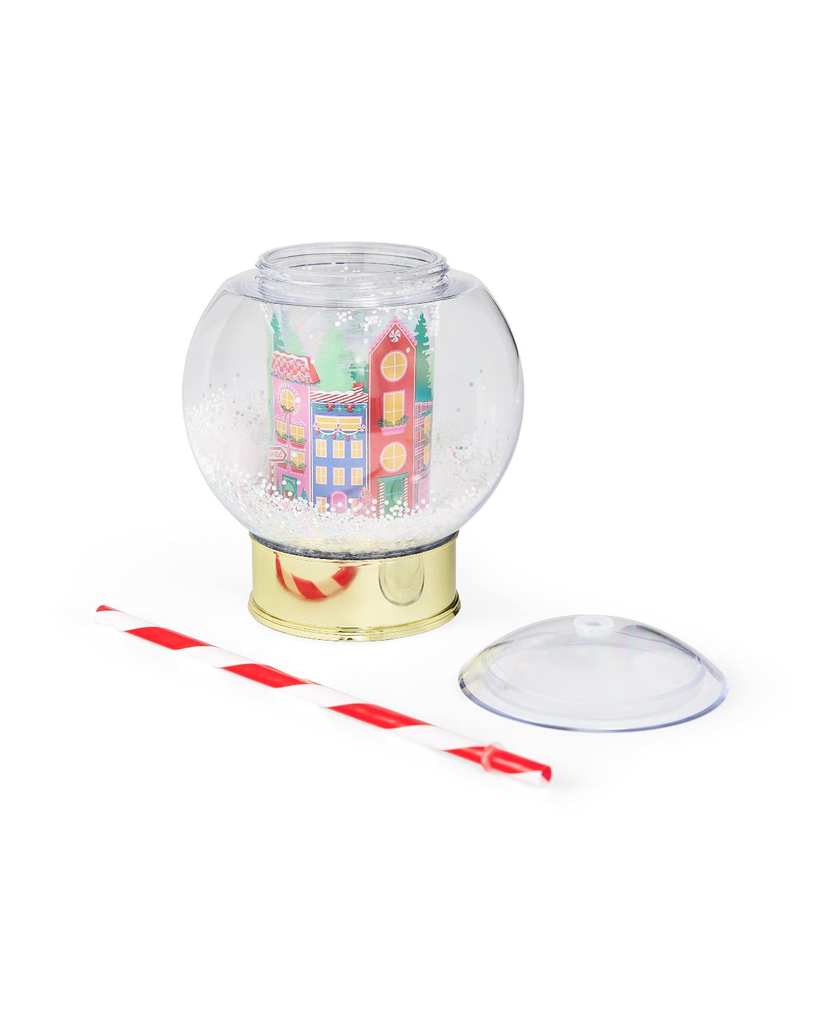 Village snow globe sipper with top and straw laying flat shot against white background. 