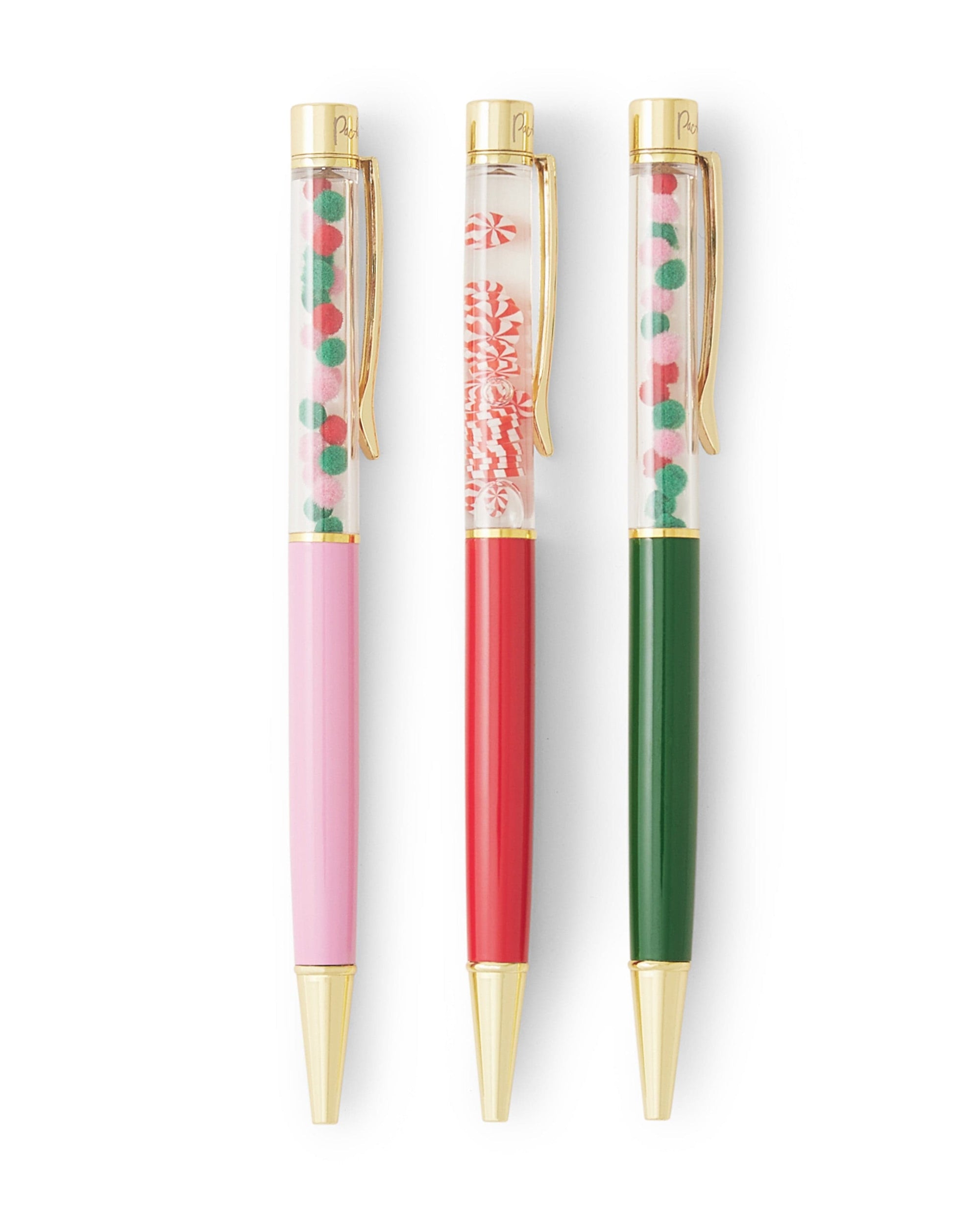 A set of pink, red, and green holiday themed ballpoint pens shot against white background.