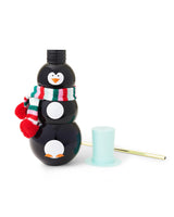 Black penguin sipper cup with mint top hat and gold straw laying down. 