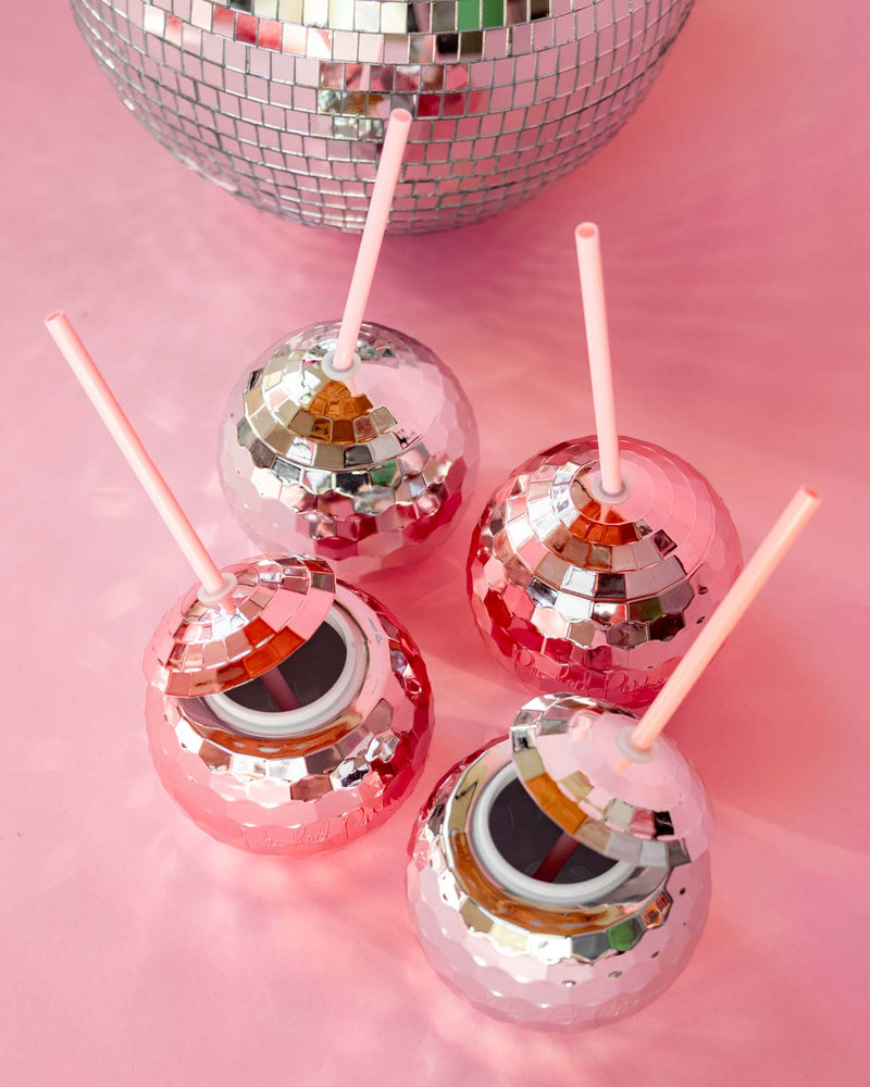 silver and rose gold disco ball shaped cups against pink background next to disco ball