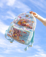 A blue confetti backpack with nylon straps and mesh pockets.