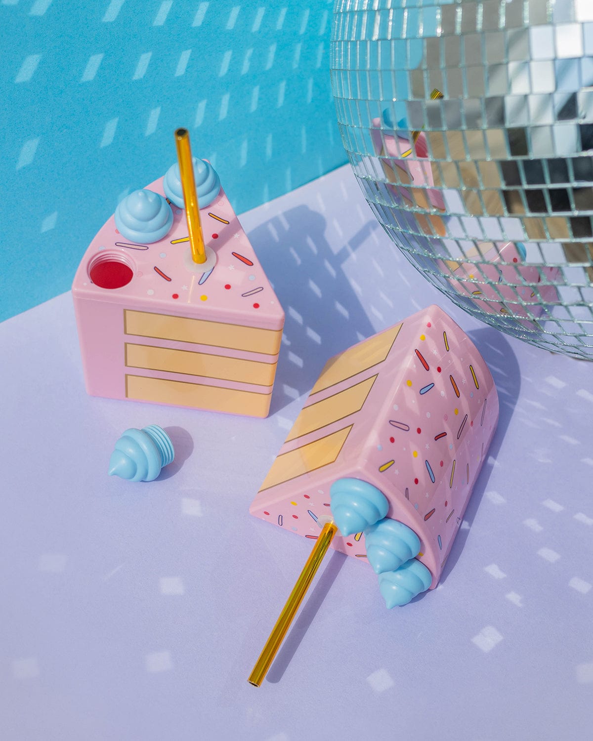  A set of 6 cake slice sippers with gold straws. Wine being poured in next to disco ball in a party scene