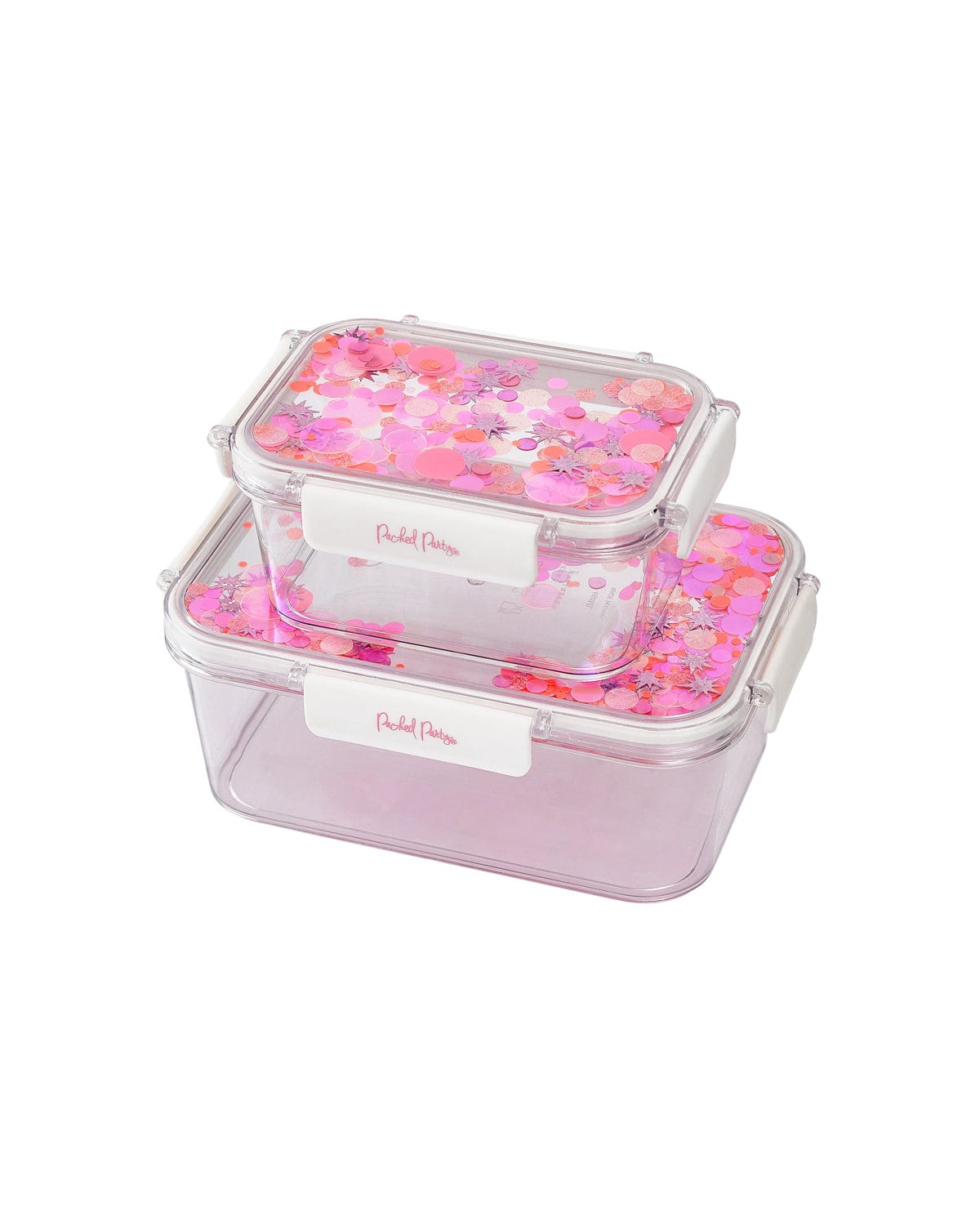 Two lunchboxes with pink confetti trapped inside the flip-top lids sit on top of eachother. One is visible smaller than the other and is sitting on top. 