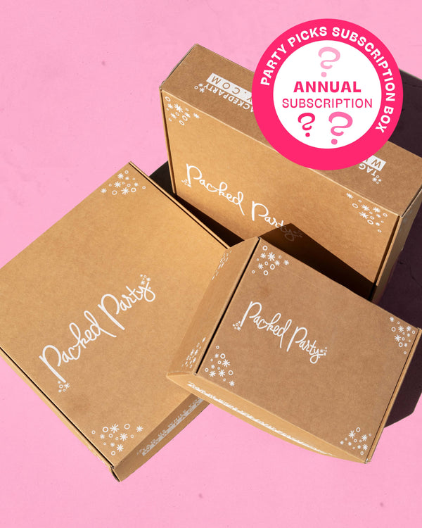 Three boxes with Packed Party logo on pink background with icon in corner of image that says "Party Picks Subscription Box Annual Subscription"