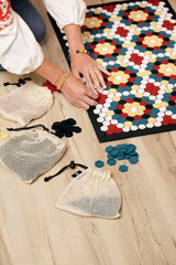 Black and white floor mat with red, blue and yellow tiles.