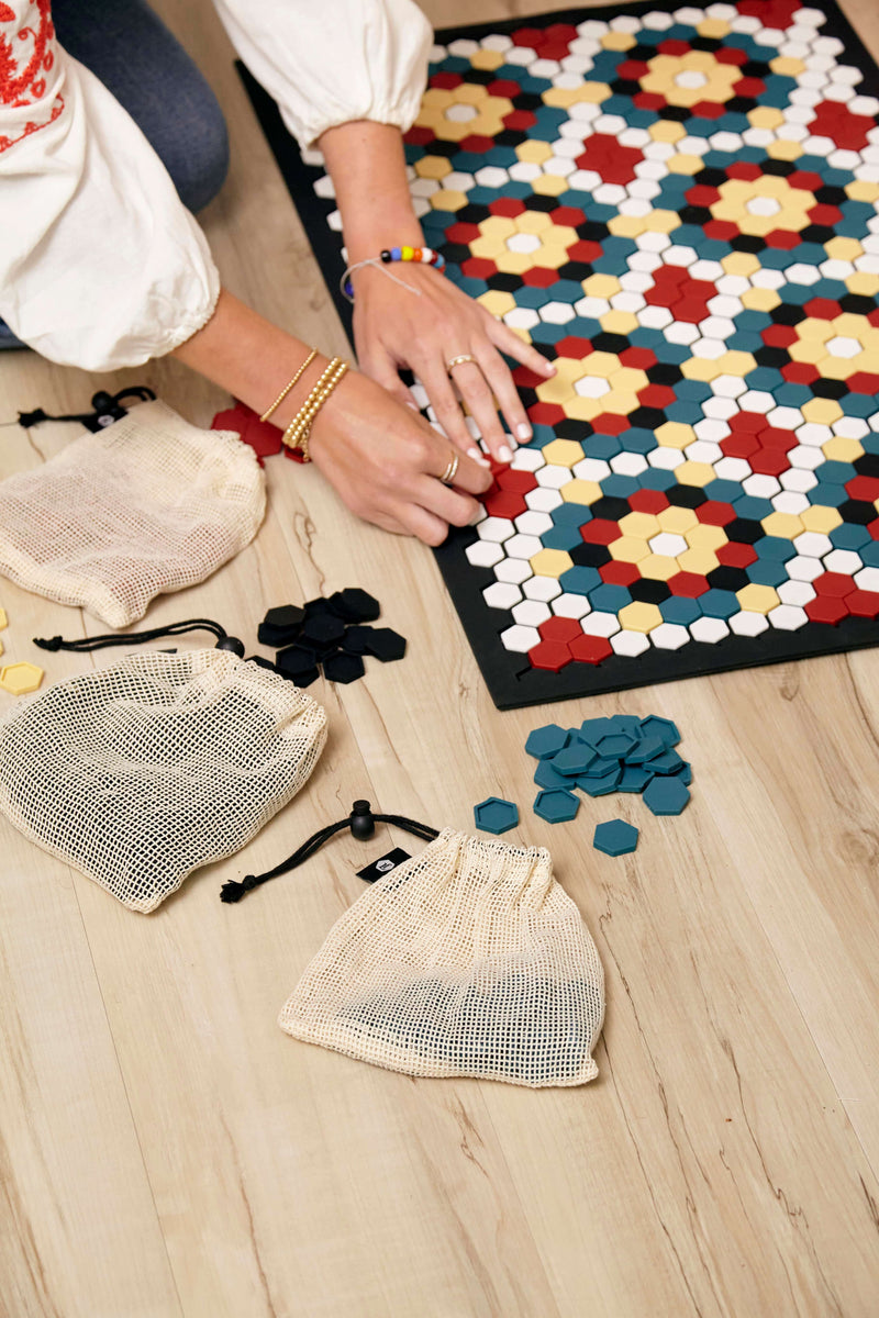 Black and white floor mat with red, blue and yellow tiles.