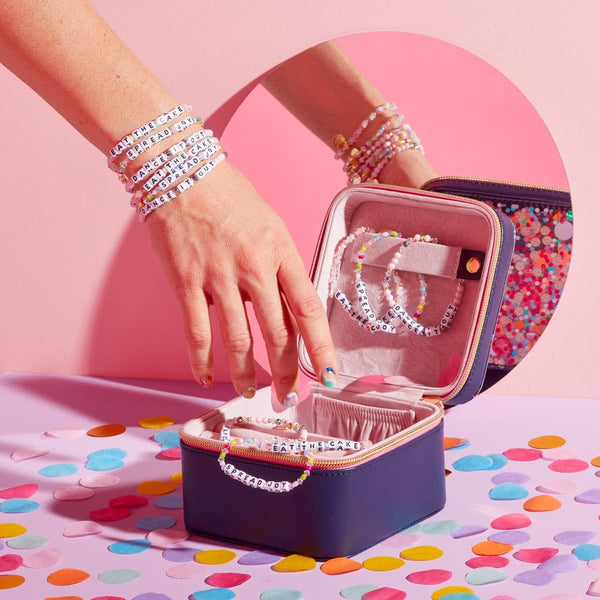 Lady's hand with 6 LWP bracelets and a jewelry case with LWP bracelets