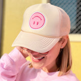 girl wearing a packed party icon hat in cream
