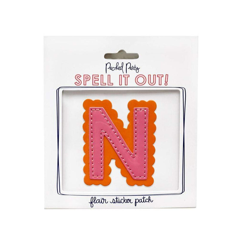 Pink and orange scalloped letter N sticker.