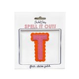 Pink and orange scalloped letter T sticker.